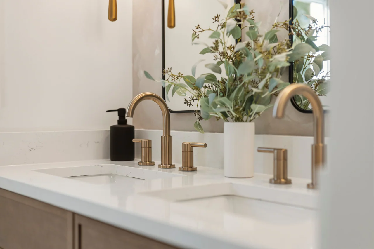 Brass faucets and mirrors at the double vanity