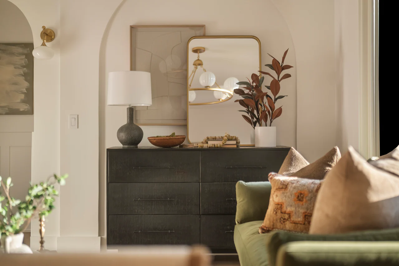 Dresser in an arched niche with mirror and lamp