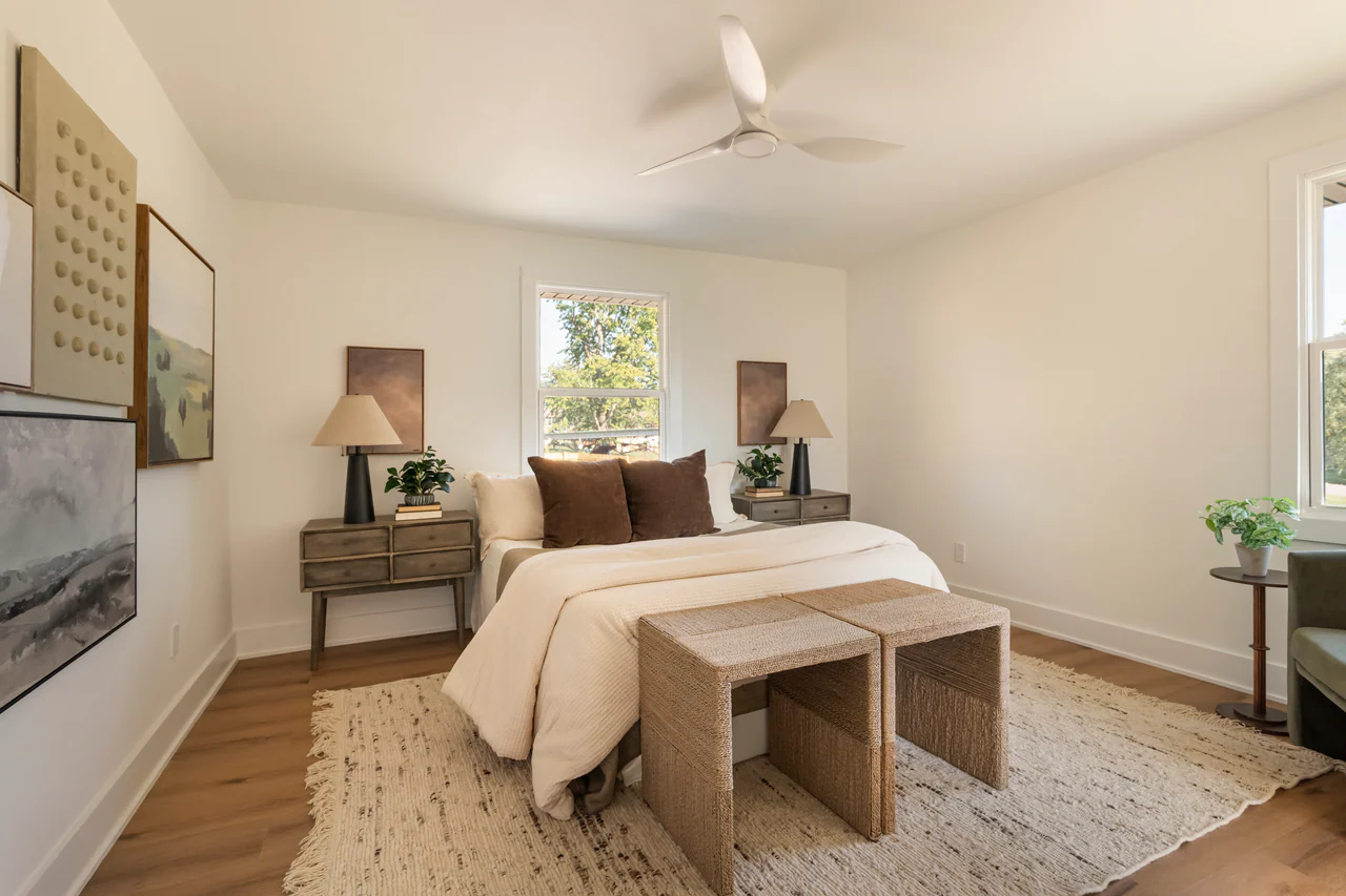 Bedroom with ceiling fan, woven benches and matching nightstands